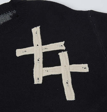 Close-up of the Cross Jacquard Knit Sweater – Loose Fit showing the unique jacquard pattern and soft texture.
