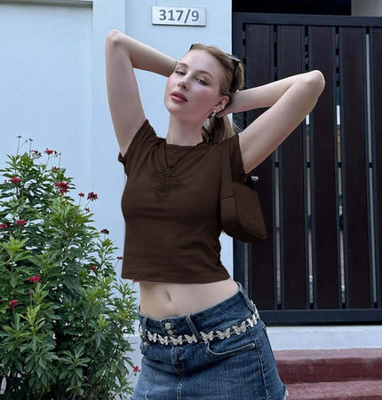 Cross Print Crop TShirt - Slim Fit, brown crop top on a model showcasing a trendy style against a vibrant outdoor background.