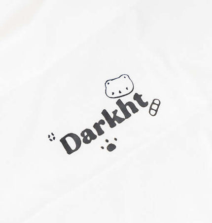 Close-up of the Darkht logo featuring playful graphics on a white fabric background.