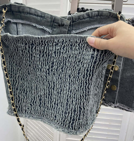 Denim Buckle Strapless Slim Fit Tank Top showing textured denim fabric and chain strap details hand-held for a stylish look.