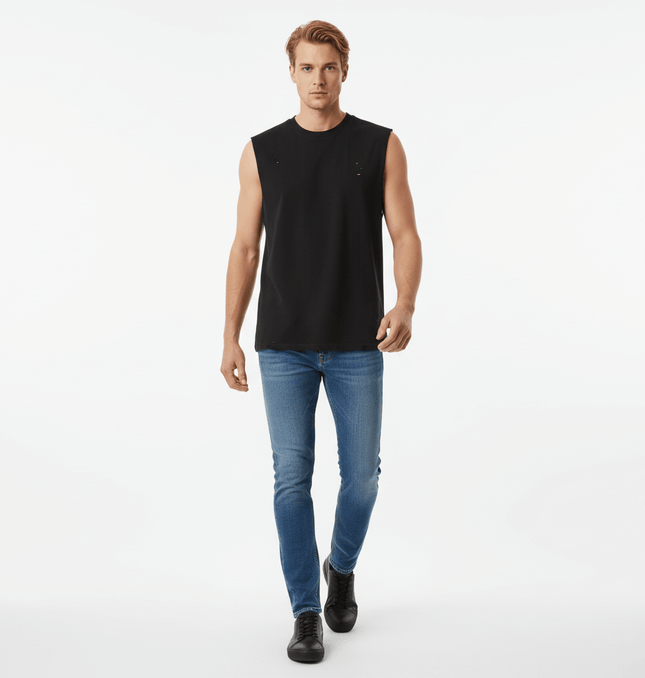 Model wearing Distressed Sport Tank Top – Loose Fit with jeans, showcasing a casual streetwear style.