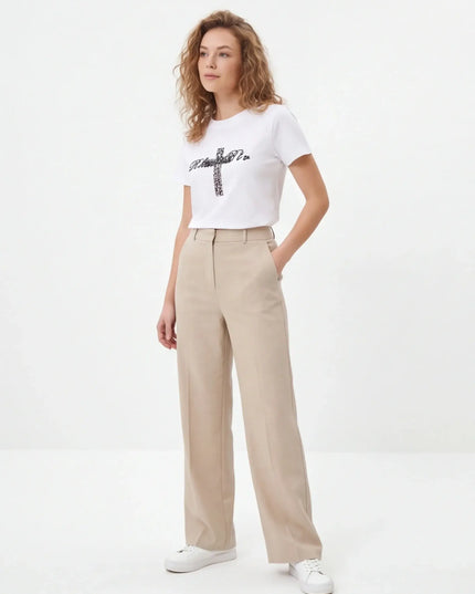 Maison Grozavu Minimalist Tee - Basalt Volume — rear view displaying the back panel detailing and structured hemline in neutral