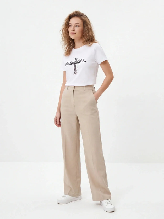 Maison Grozavu Minimalist Tee - Basalt Volume — rear view displaying the back panel detailing and structured hemline in neutral