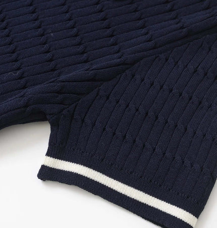 Close-up of the Eight-Strand Braided Knit Top – Loose Fit showcasing navy blue textured knit and striped cuffs.
