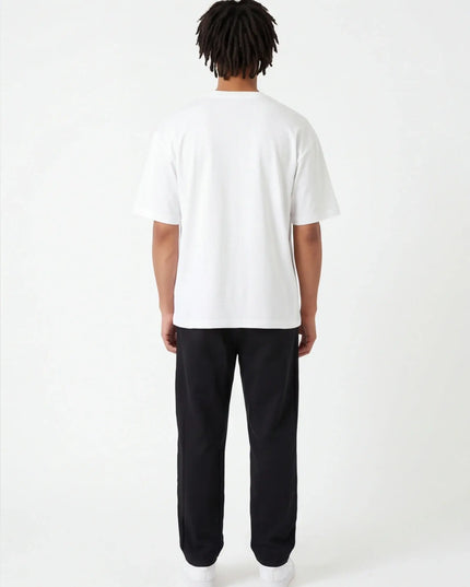 Rear view of the Maison Grozavu Tailored Alabaster Tee in shirt — showing the sleek silhouette.