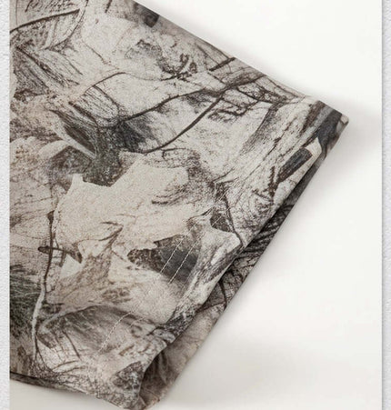 Close-up of the fabric showing the branch camouflage pattern of the Camouflage Drop-Shoulder TShirt – Loose Fit.