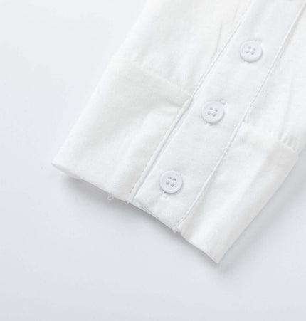 Fitted Long Sleeve Deconstructed TShirt close-up showing buttoned cuff detail on a soft white fabric.