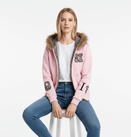 Fleece Lined Leopard Ears Hoodie modeled by a woman sitting on a stool, featuring a pink color and leopard ear hood.