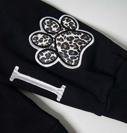 Close-up of the Fleece Lined Leopard Ears Hoodie showcasing leopard print paw print detail on the sleeve.