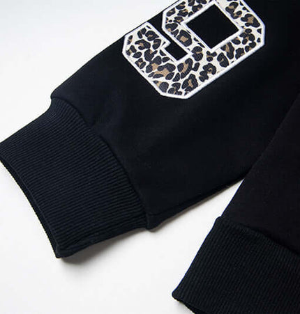 Detail of the Fleece Lined Leopard Ears Hoodie featuring leopard print accents on sleeves.