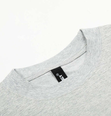 Graffiti Letter Print TShirt – Loose Fit showing a close-up of the classic round neckline and label design.