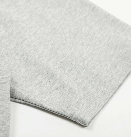 Close-up of the soft cotton blend fabric on the sleeve of the Graffiti Letter Print TShirt – Loose Fit.