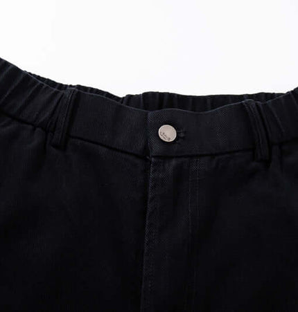 Close-up of the waistband and button detail on Graffiti Printed Cargo Denim Pants.