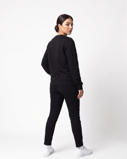 Full body rear view of model Sienna wearing GROZAVU Black Crewneck Sweatshirt showcasing rear garment structure and back artwork