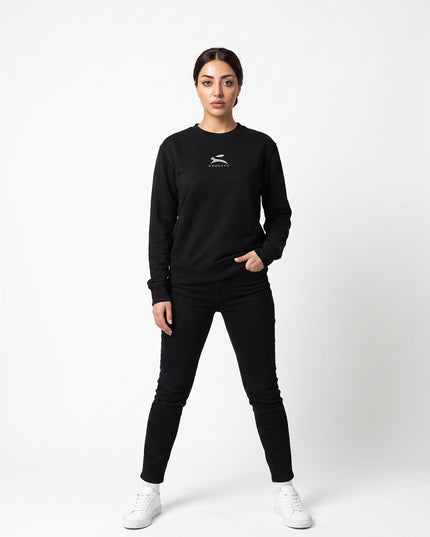 Straight-on front full-body view of model Sienna wearing GROZAVU Black Crewneck Sweatshirt in seamless white studio