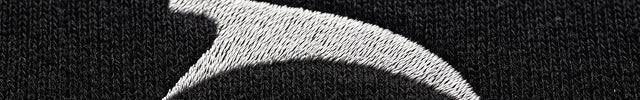 Extreme macro close-up of GROZAVU Black Crewneck Sweatshirt showcasing premium heavyweight fabric weave, tactile ribbing, and razor-sharp graphic print detail
