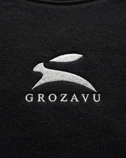 Extreme macro close-up of GROZAVU Black Crewneck Sweatshirt showcasing premium heavyweight fabric weave, tactile ribbing, and razor-sharp graphic print detail