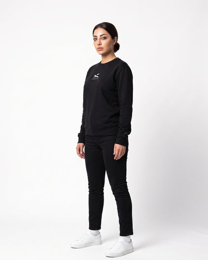 Left-side profile of model Sienna wearing the Grozavu Black Crewneck Sweatshirt in 350 g/m² organic cotton