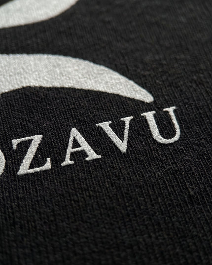 Extreme macro close-up of GROZAVU Black T-Shirt showcasing premium heavyweight fabric weave, tactile ribbing, and razor-sharp graphic print detail