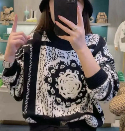 Camellia Jacquard Beaded Knit Sweater worn by a woman in a stylish black and white design with artistic details.