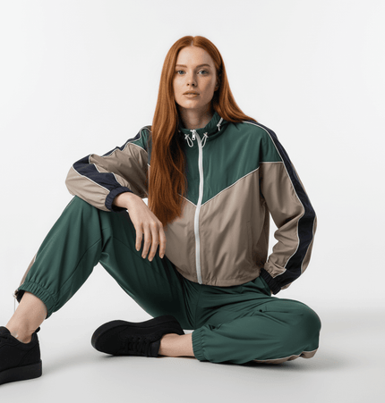 Color Block Jacket and Long Pants Set modeled by woman with long red hair, sitting stylishly on white background.