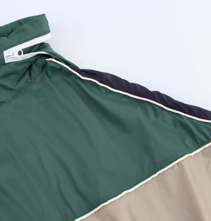 Close-up view of the Grozavu Color Block Jacket showcasing its bold green, beige, and navy color scheme.