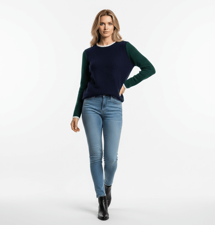 Woman wearing a Color Block Patchwork Knit Sweater with long sleeves and blue jeans, standing confidently.