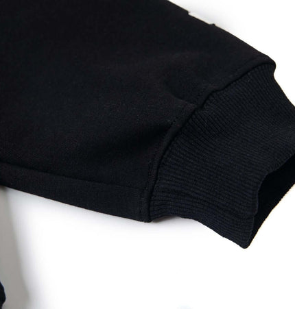 Close-up of the sleeve cuff of the Cross Embroidered Hoodie – Loose Fit, showcasing its high-quality fabric and design details.