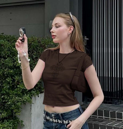 Cross Print Crop TShirt - Slim Fit worn by a woman taking a photo, showcasing bold street style and a trendy cropped design.