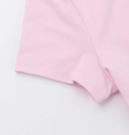 Close-up of the sleeve of the Cross Print Crop TShirt - Slim Fit in soft pink fabric.