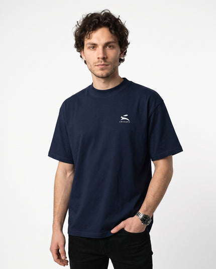 Dynamic 3/4 angled upper-body zoom of model Jax wearing GROZAVU Dark Navy T-Shirt highlighting garment drape, fit, and side profile