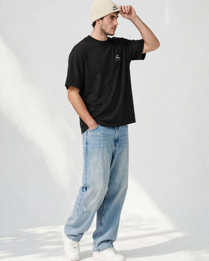 Model adjusting the ribbed-knit fisherman beanie in a studio shot