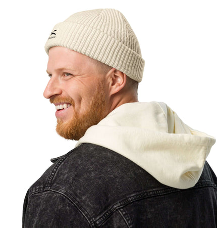 Man wearing a Grozavu beanie with a hoodie, showcasing cozy style and warmth in chilly weather.
