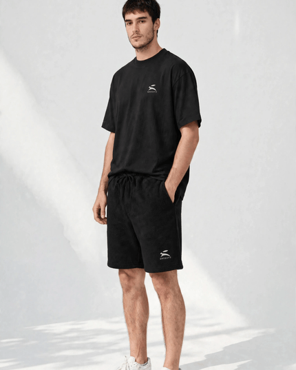 Three-quarter view of the black fleece shorts with tapered knee
