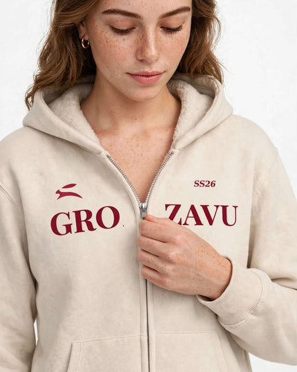 Close-up of the silver metal zip on the beige full-zip hoodie