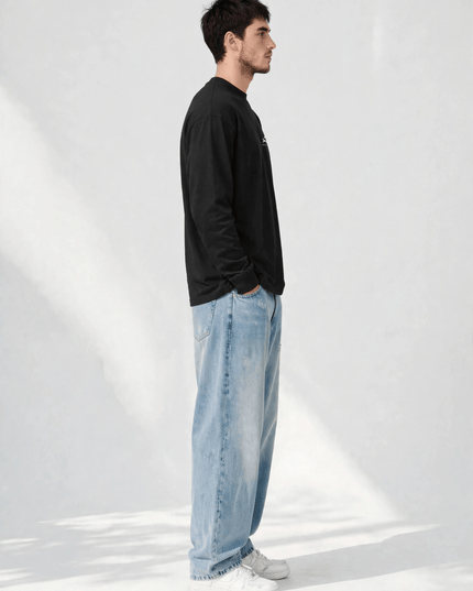 Side profile of the black long sleeve tee showing the ribbed cuff