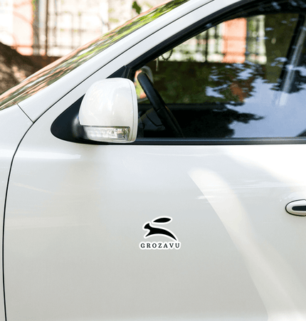Kiss-cut vinyl decals on a white car door featuring a sleek rabbit design with the text 'GROZAVU'.