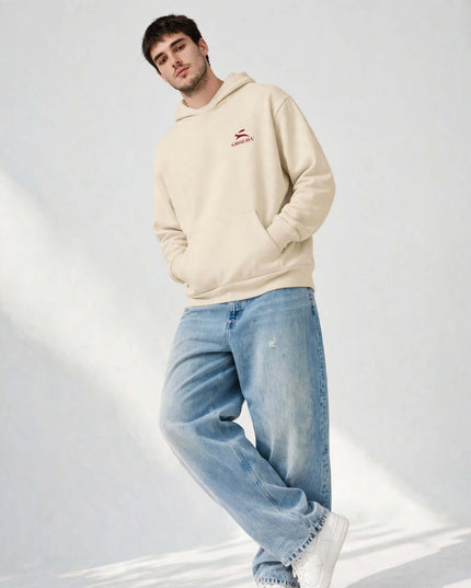 Low-angle shot of the beige oversized mill-dyed hoodie
