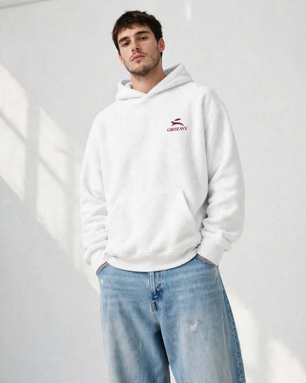 Low-angle streetwear shot of the white oversized mill-dyed hoodie
