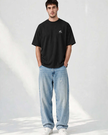Black oversized organic tee in 200 g/m² GOTS cotton, worn front view