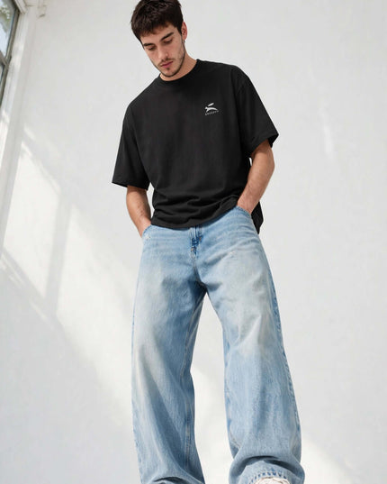 Low-angle dynamic shot of the black oversized organic tee