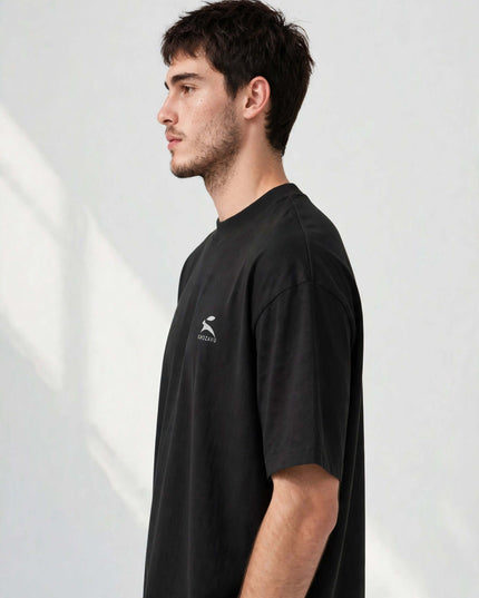Side profile of the black oversized organic tee with dropped shoulders