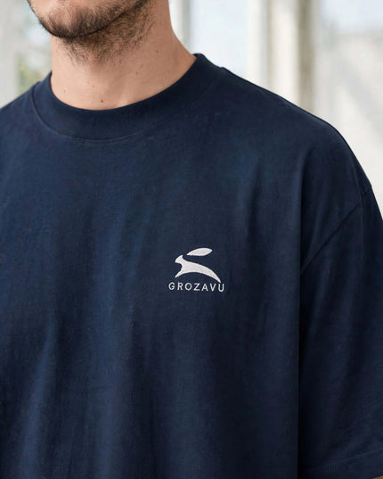 Close-up of the Grozavu hare embroidery on the navy organic tee