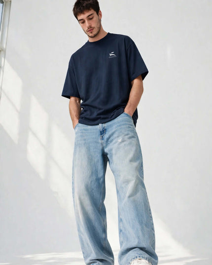 Low-angle shot of the navy oversized organic tee with dropped shoulders