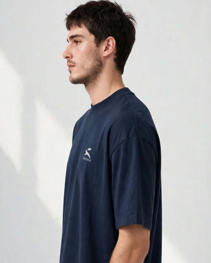 Side profile of the navy 200 g/m² organic tee showing the relaxed drop-shoulder line