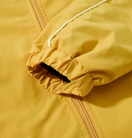 Close-up of the sleeve detail of the Retro Hooded Zip Jacket – Loose Fit in yellow fabric.