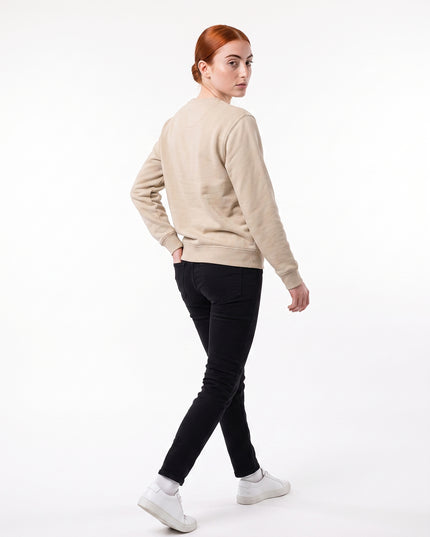 Full body rear view of model Sienna wearing GROZAVU SS26 Beige Crewneck Sweatshirt showcasing rear garment structure and back artwork