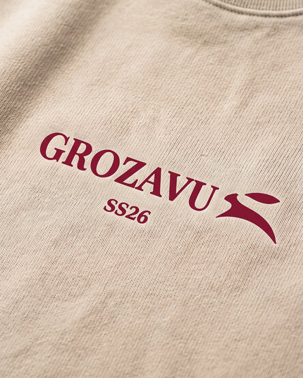 Extreme macro close-up of GROZAVU SS26 Beige Crewneck Sweatshirt showcasing premium heavyweight fabric weave, tactile ribbing, and razor-sharp graphic print detail