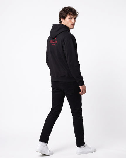 Full body rear view of model Jax wearing GROZAVU SS26 Black Hoodie showcasing rear garment structure and back artwork