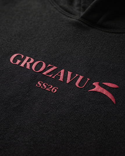 Extreme macro close-up of GROZAVU SS26 Black Hoodie showcasing premium heavyweight fabric weave, tactile ribbing, and razor-sharp graphic print detail